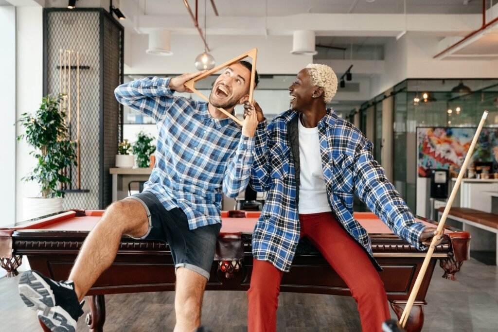 A couple having fun in dining-living room with billiard table A couple having fun in dining-living room with billiard table
