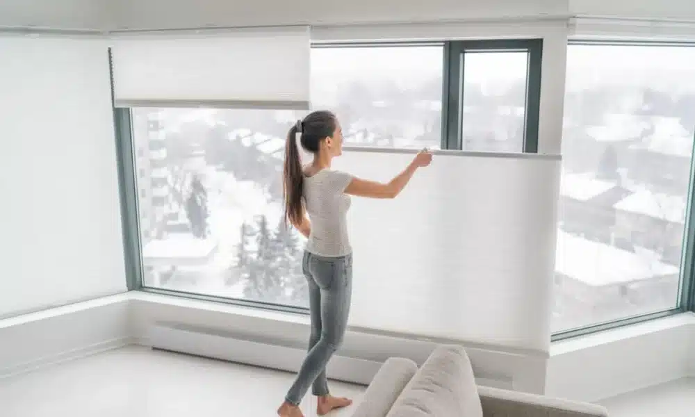 Woman opening home curtains in urban condo 1200x800.jpeg