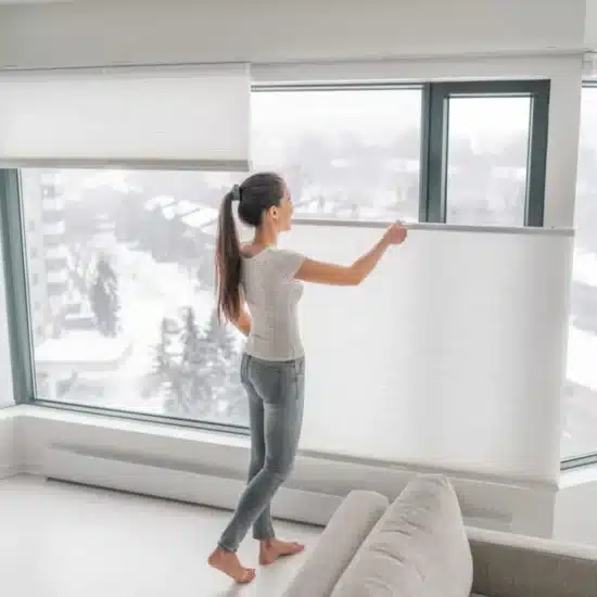 Woman opening home curtains in urban condo 1200x800.jpeg
