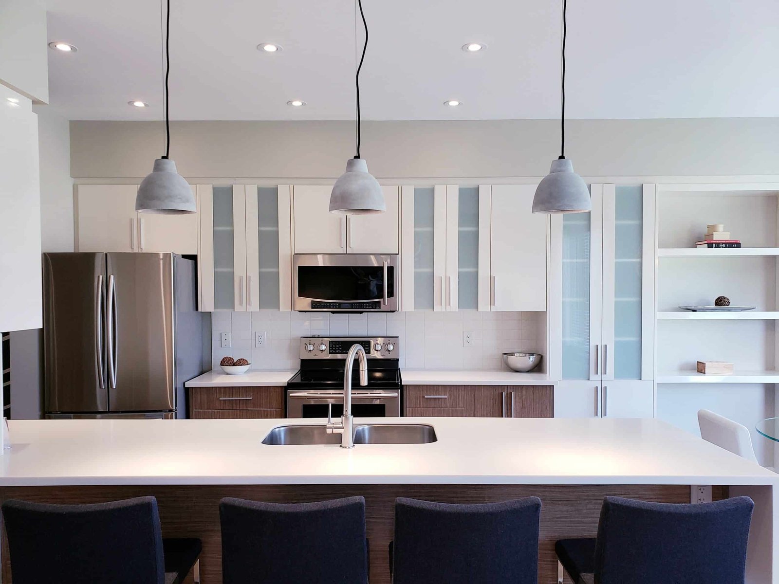 Modern design kitchen cabinets in white and tinted glass, quartz countertop