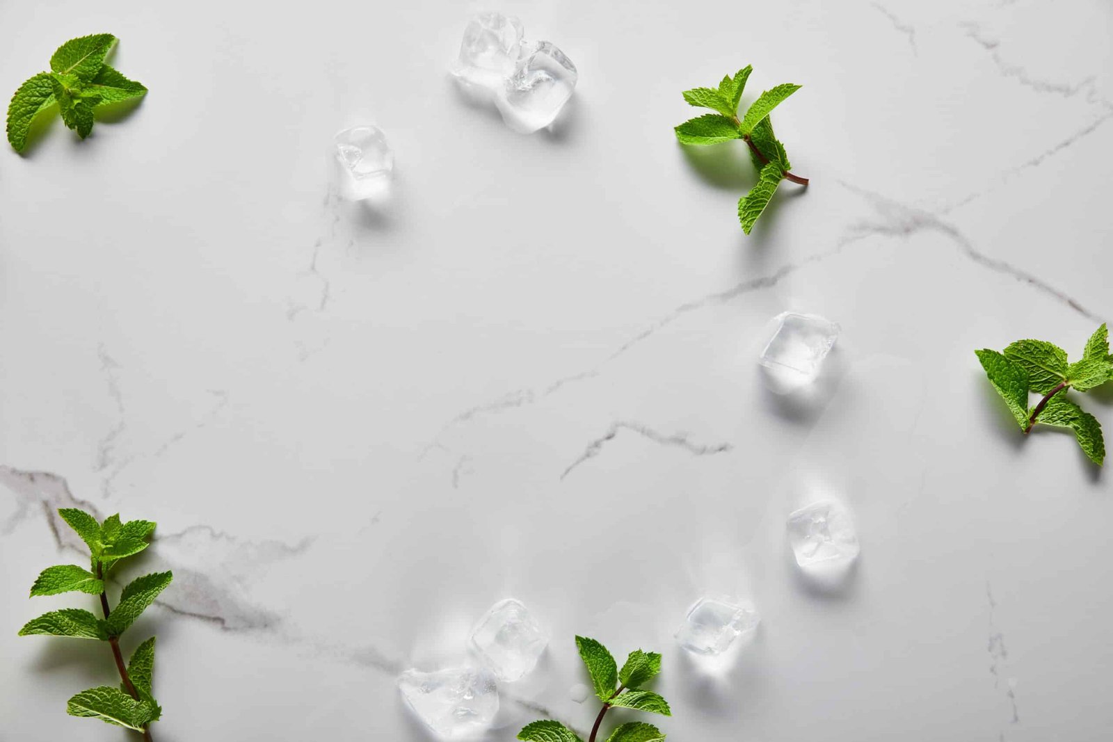 Quartz top view of green fresh mint and ice cubes