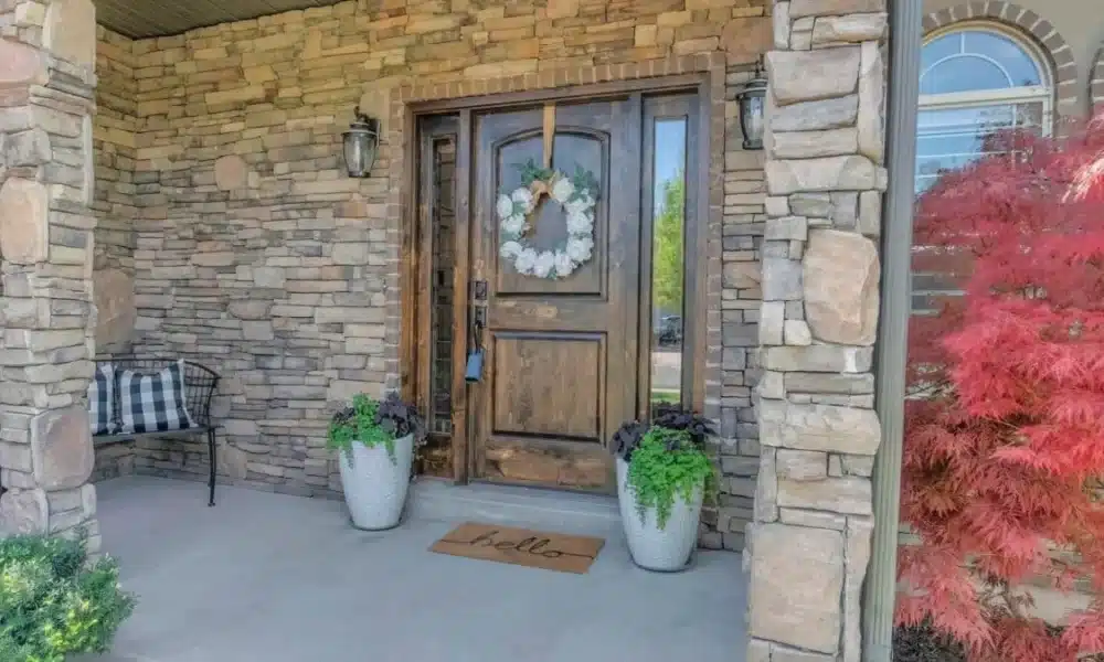 Front door exterior with stone wall 1200x675 1