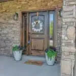 Front door exterior with stone wall 1200x675 1