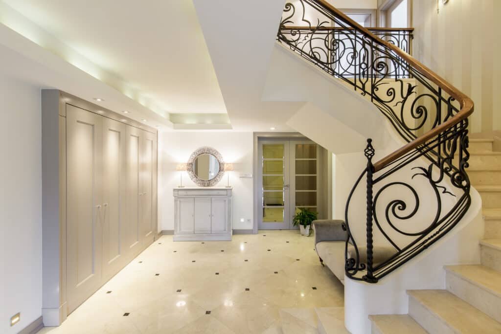 Light and spacious hallway with staircase with decorative railing