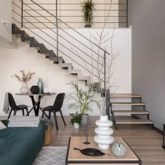 Stylish living room with dining table under staircase 1200x800 1
