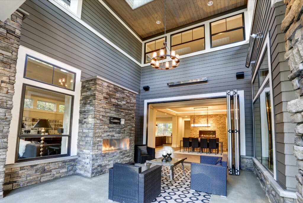 Covered patio boasts high outdoor ceiling lights with skylights