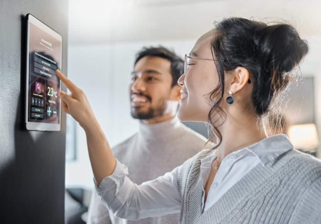 Smart home technology, wall system and couple with digital dashboard of house automation Smart home technology, wall system and couple with digital dashboard of house automation