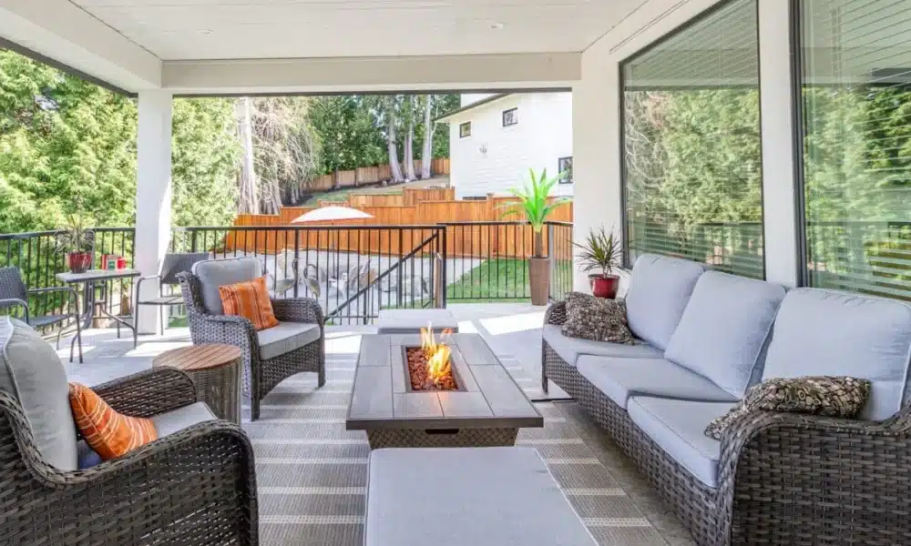 A luxurious spacious deck with stylish patio furniture with a fire pit table heater 1200x800 1