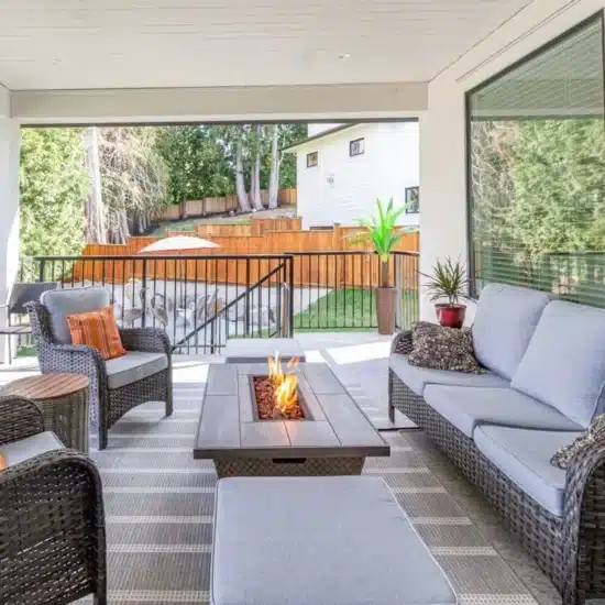 A luxurious spacious deck with stylish patio furniture with a fire pit table heater 1200x800 1