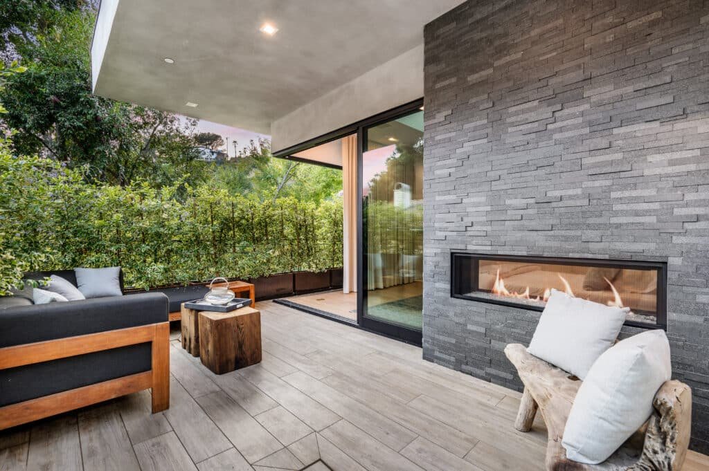 Patio backyard with fireplace and wooden furniture Patio backyard with fireplace and wooden furniture