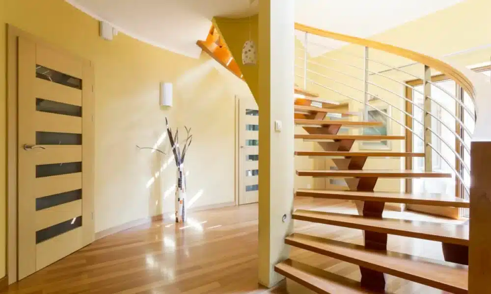 Spiral wooden staircase and doors in modern spacious interior 1200x800 1