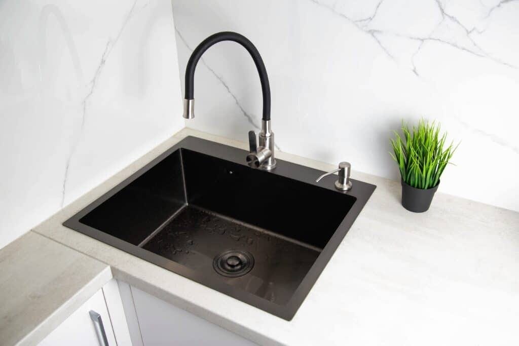Modern kitchen sink with detergent dispenser and faucet
