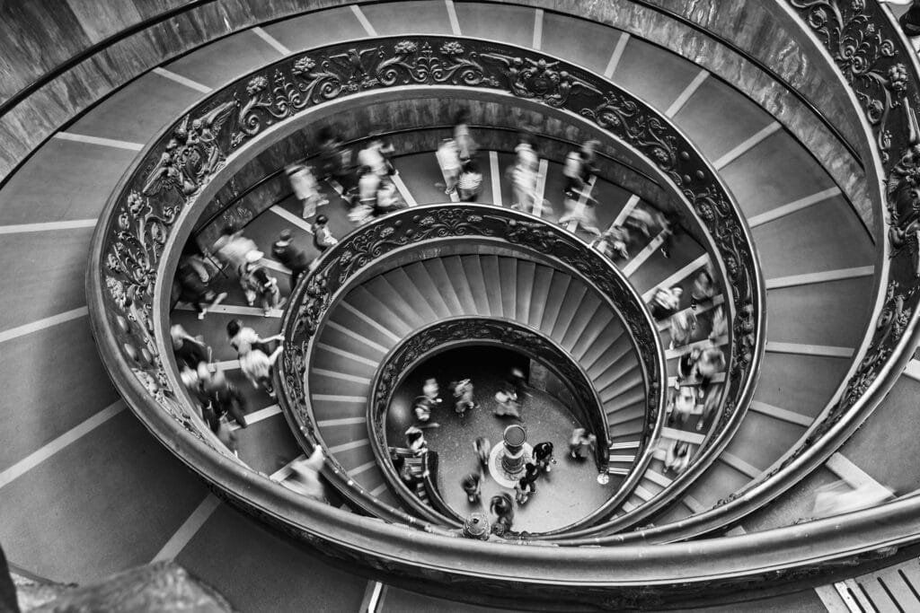 People descending spiral staircase People descending spiral staircase