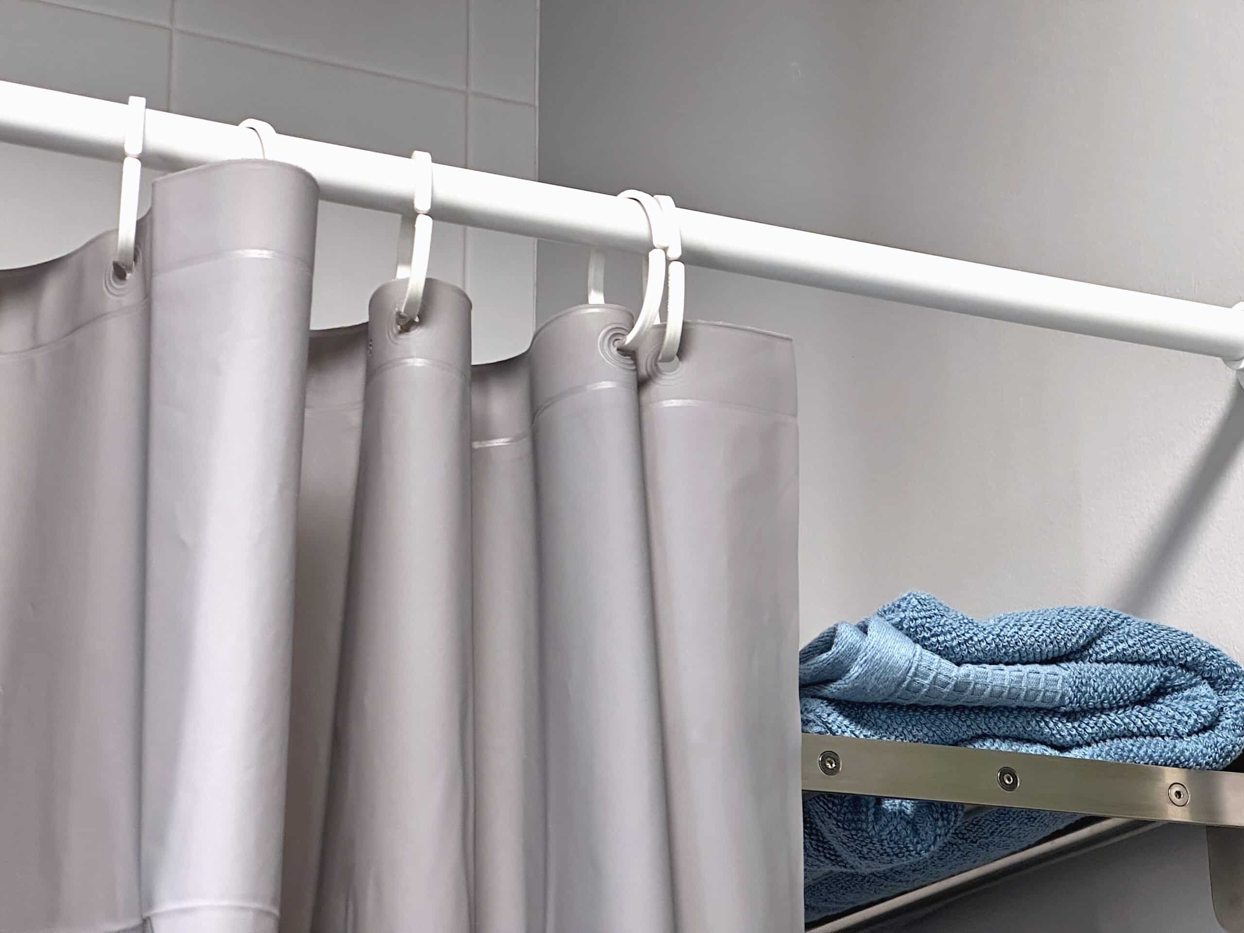 PEVA shower curtain with a towel on the rack