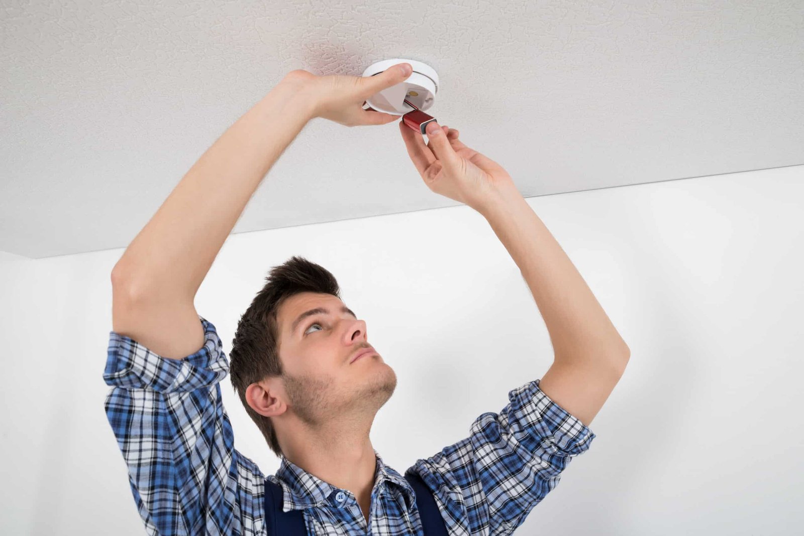 Electrician Repairing Carbon Monoxide(CO) Detector Electrician Repairing Carbon Monoxide(CO) Detector