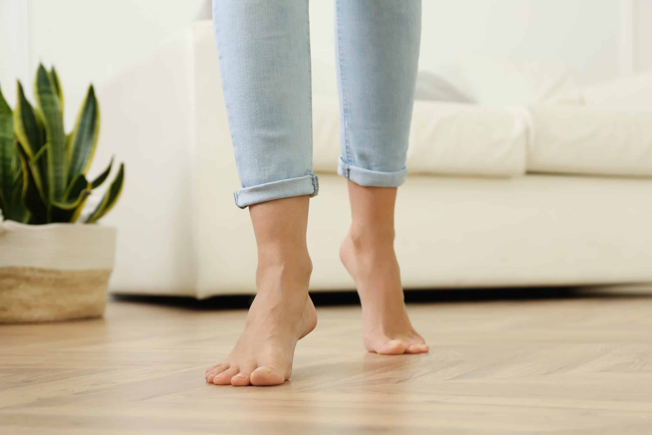 A person's feet on a radiant floor heating concept 