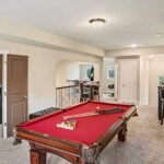 A home game room with a pool table scaled 1